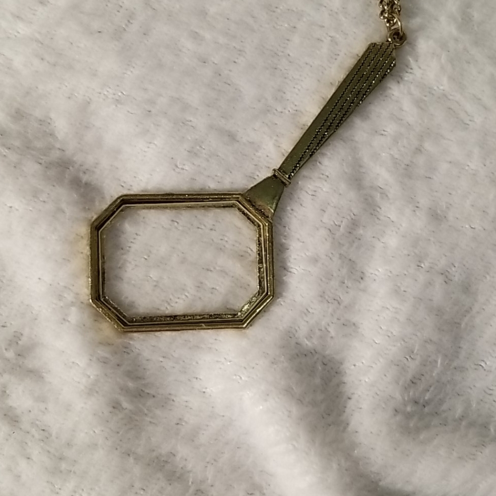 Gold magnifying glass necklace